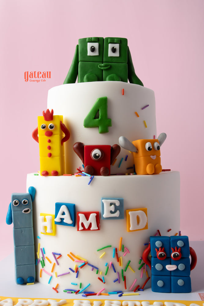 Colorful number blocks birthday cake with playful figures for children's celebrations