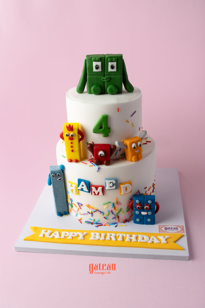 Colorful number blocks birthday cake with playful decorations and a personalized message for a birthday celebration