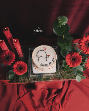 Order Flork cake online from Gateau Gourmet Cafe decorated with red flowers and greenery on a red fabric background