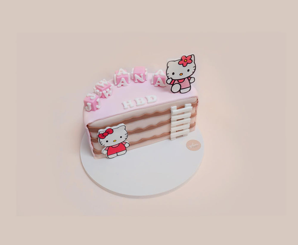 Personalized kids birthday cake with pink frosting and Hello Kitty decorations from Gateau Gourmet Cafe
