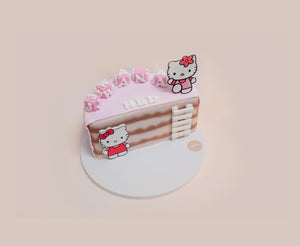 Personalized kids birthday cake with pink frosting and Hello Kitty decorations from Gateau Gourmet Cafe