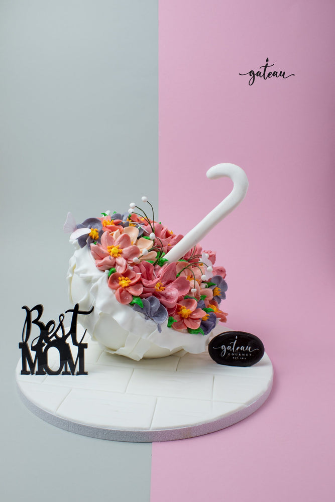 Personalized Mother's Day cake shaped like an umbrella with colorful flowers by Gateau Gourmet Cafe