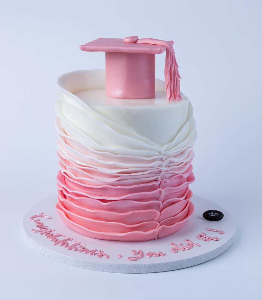 Pink Chic Graduate Cake Design featuring a graduation cap and elegant ruffled layers in pink and white
