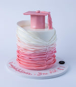 Pink Chic Graduate Cake Design featuring a graduation cap and elegant ruffled layers in pink and white