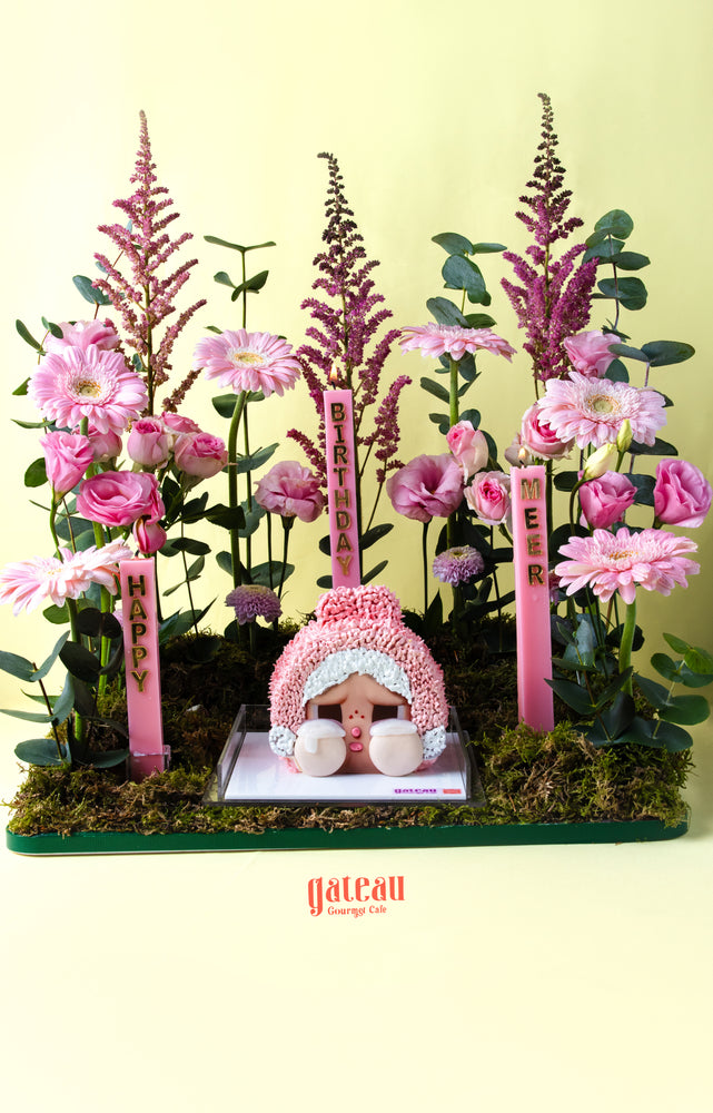 Gateau Gourmet Cafe Powerpuff Girls themed dessert cake with pink floral decorations and birthday candles