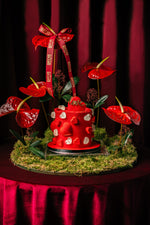 Pure Heart Cake With Arrangement featuring red decorations and heart motifs on a floral display