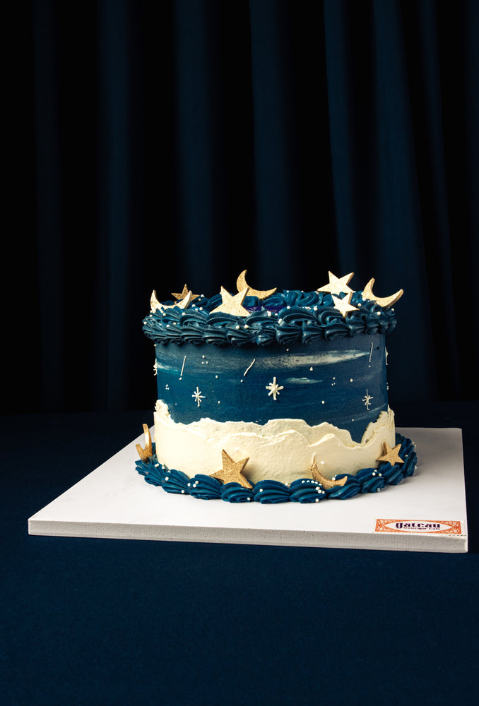 Gateau Gourmet Cafe Ramadan celebration cake with blue and white frosting and gold star and moon decorations