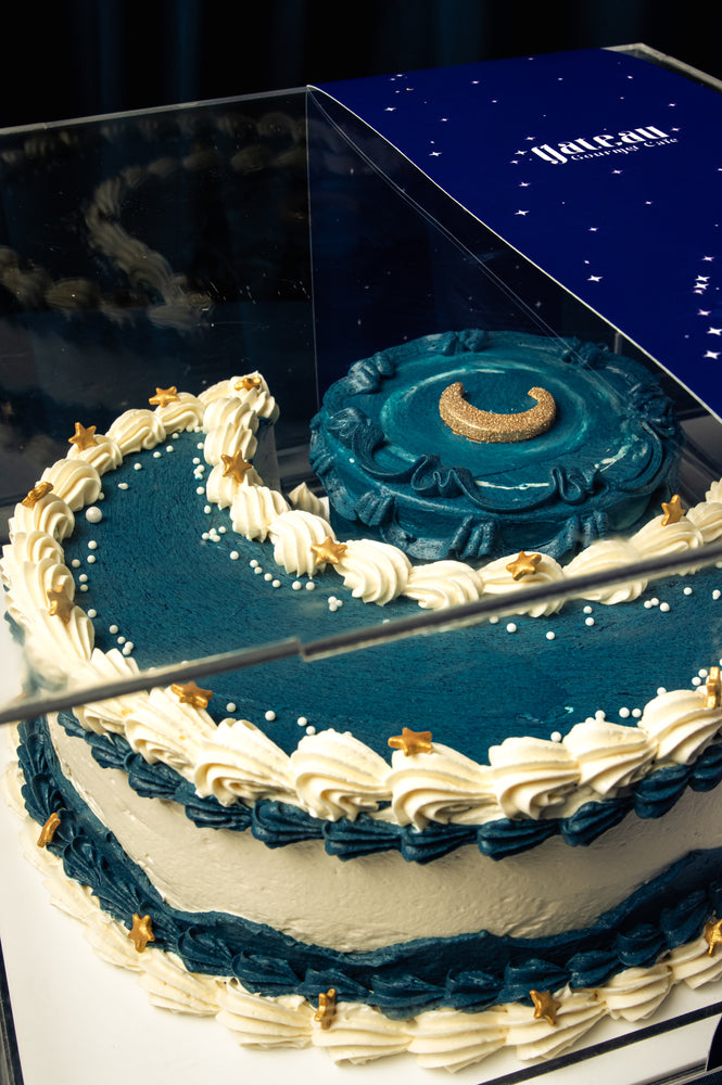 Ramadan crescent cake by Gateau Gourmet Cafe with blue and white frosting decorated with crescent moon and stars