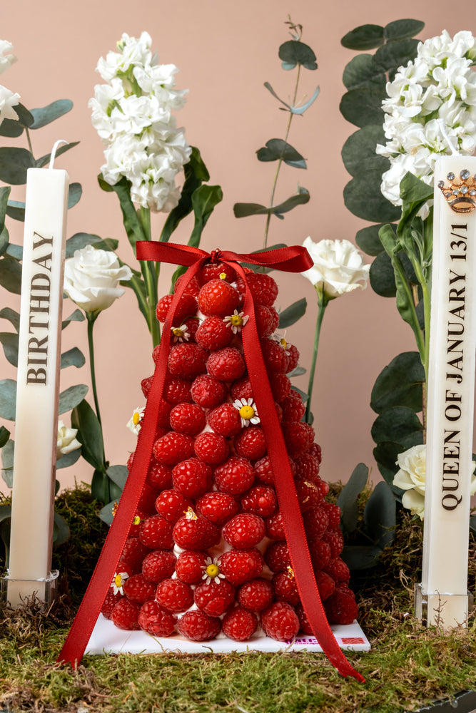 Raspberry mountain centerpiece from Gateau Gourmet Cafe decorated with fresh flowers and candles