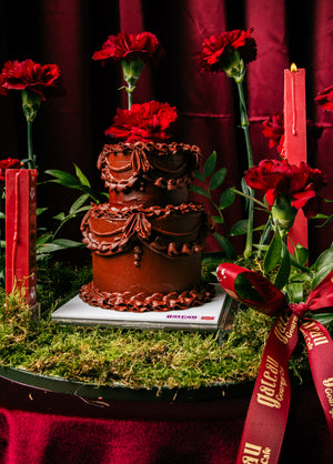 Red mini classic cake chocolate frosted two-tier cake by Gateau Gourmet Cafe with red flowers and candles