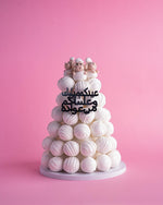 Sheep truffle cake tower with white truffles and cute sheep figures on top by Gateau Gourmet Cafe