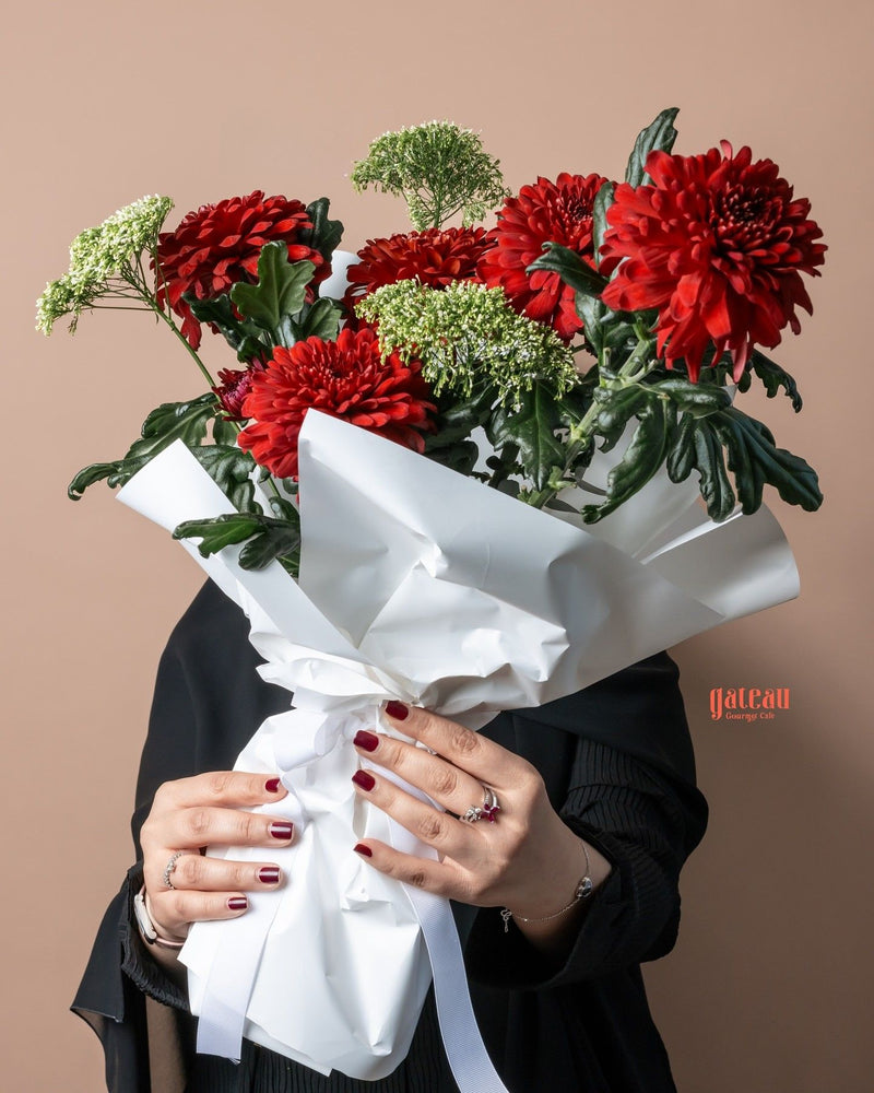 Special Red Chrysanthemum Flower Bouquet wrapped in white paper, held by a person with stylish nails