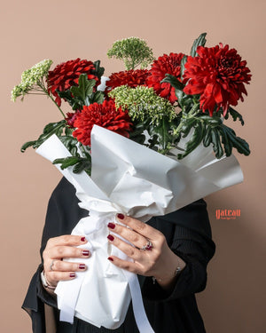 Special Red Chrysanthemum Flower Bouquet wrapped in white paper, held by a person with stylish nails