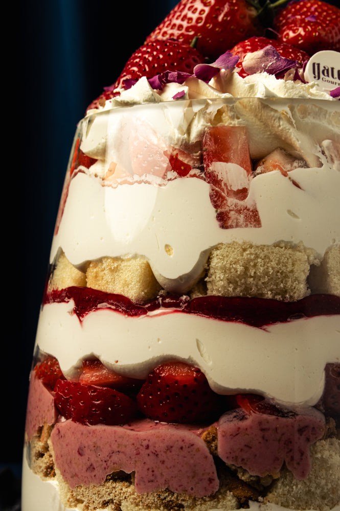 Delicious Strawberry Goblet dessert layered with cream, cake, strawberries, and raspberry sauce