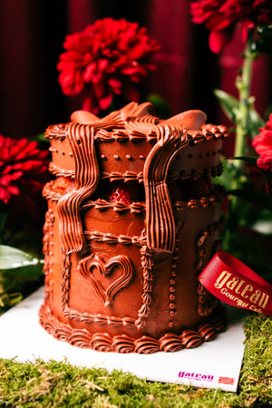 Strawberry Red Box Cake by Gateau Gourmet Cafe decorated with chocolate frosting and heart design
