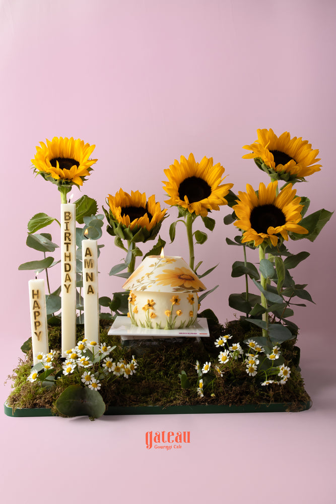 Sunflower cake arrangement with birthday candles and fresh sunflowers for a festive celebration