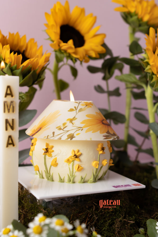 Beautiful sunflower cake arrangement from Gateau Gourmet Cafe with decorative flowers and a candle