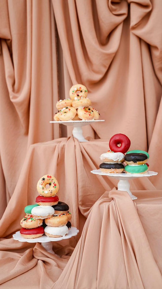 Colorful Sweet Dessert I7tifal display with layered donuts on decorative stands
