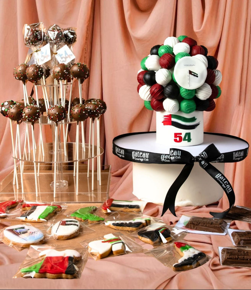 National Day themed desserts including cake pops, cookies, and a decorative cake with festive colors