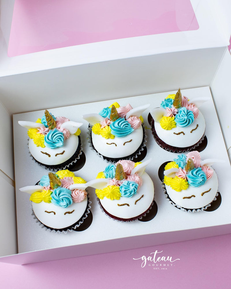 Unicorn cupcakes delivery from Gateau Gourmet Cafe featuring colorful frosting and golden horns in a white box