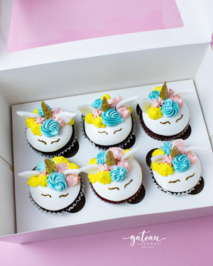 Unicorn cupcakes delivery from Gateau Gourmet Cafe featuring colorful frosting and golden horns in a white box