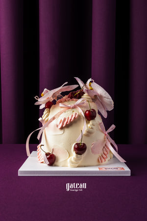 Unique birthday cake with cherries decorated with pink flowers and cream from Gateau Gourmet Cafe