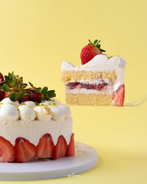 Vanilla Strawberry Cake slice topped with fresh strawberry and whipped cream from Gateau Gourmet Cafe