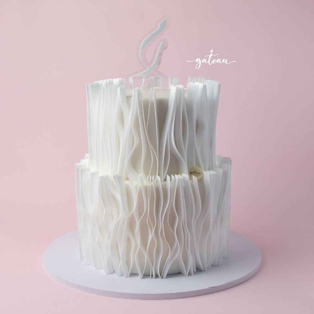 Elegant white wafer paper wedding cake with delicate ruffled layers by Gateau Gourmet Cafe