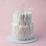 Elegant white wafer paper wedding cake with delicate ruffled layers by Gateau Gourmet Cafe