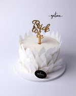 Elegant white wedding celebration cake with petal design and bride to be topper by Gateau Gourmet Cafe