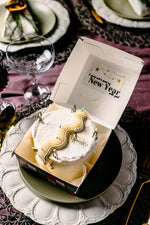 Gateau Gourmet Cafe White Snow Mountain Design Cake in a box on a decorative plate for New Year celebration